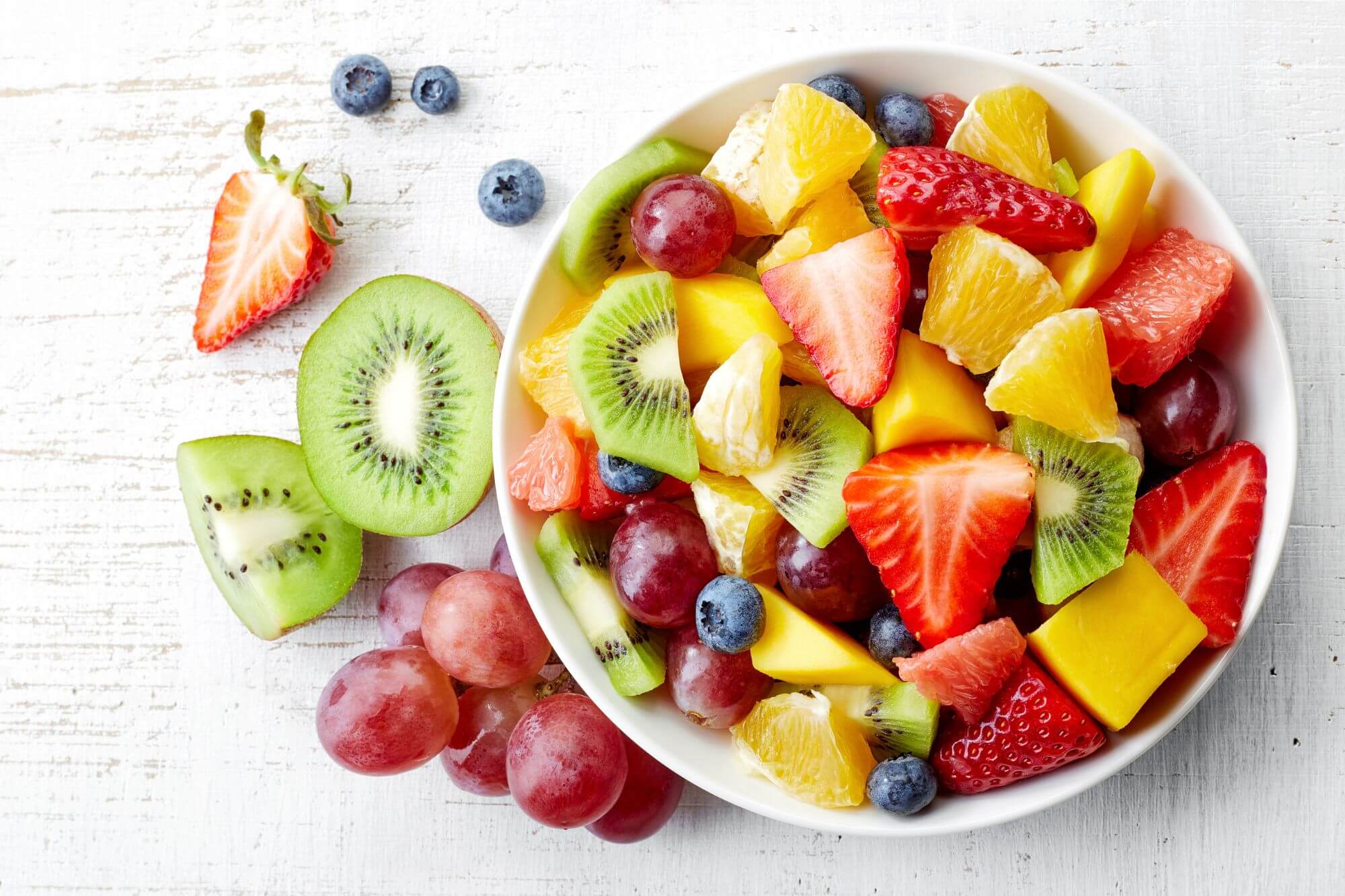 Bowl of mixed fruit on a white table